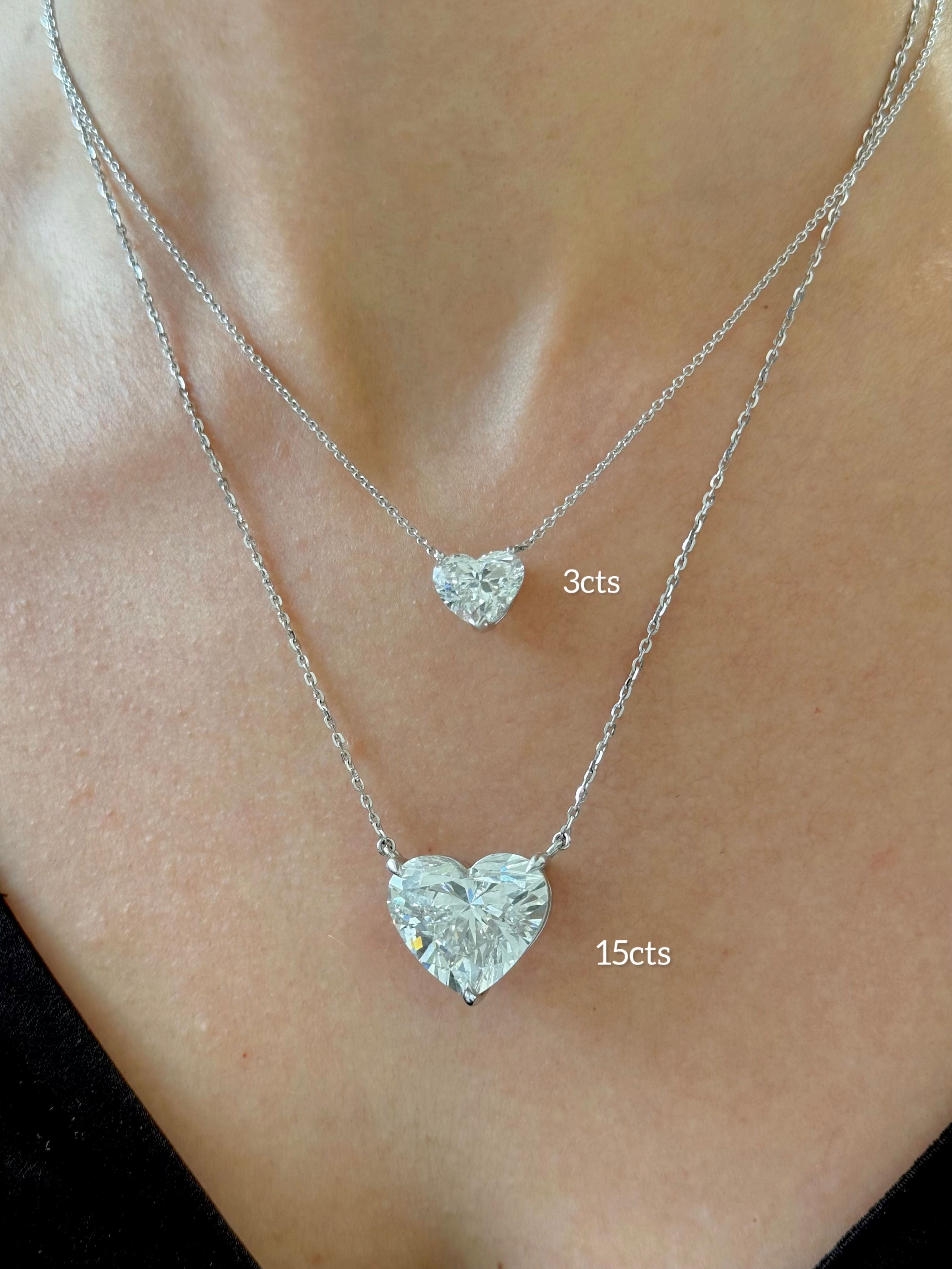 Lab-grown diamond heart pendant scale comparison showing 3 carat and 15 carat sizes worn on neck in 14k white gold