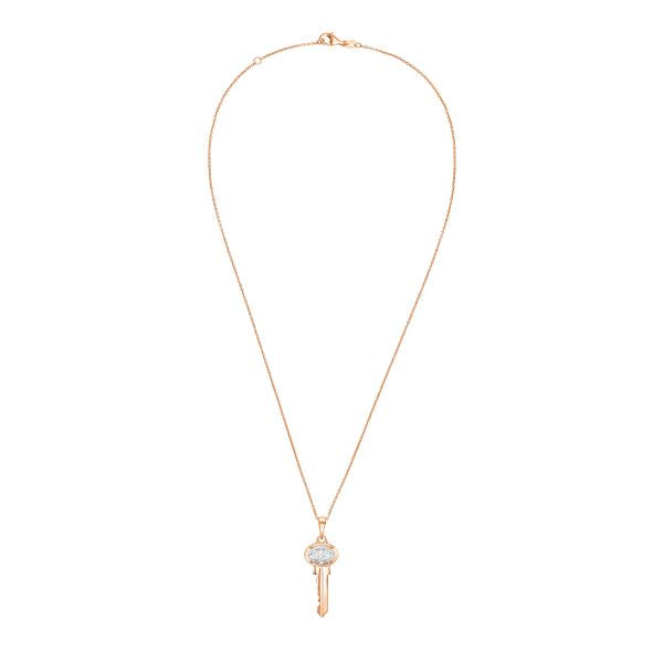 Gold necklace with a key-shaped pendant on a white background