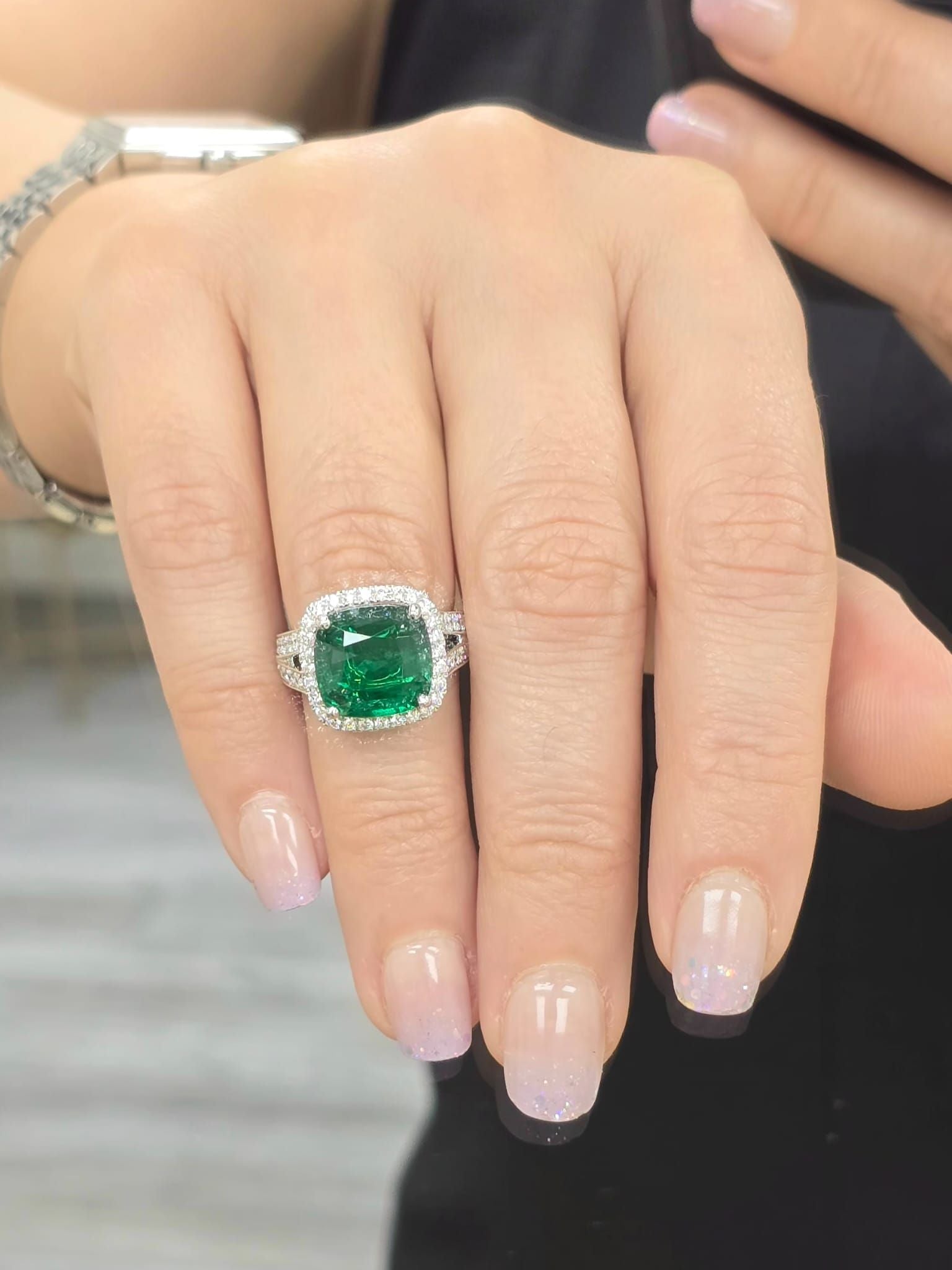 White gold emerald statement ring with micropavé halo and split shank band