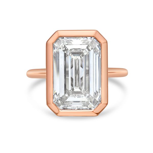 Rose gold ring with a large emerald-cut diamond on a white background