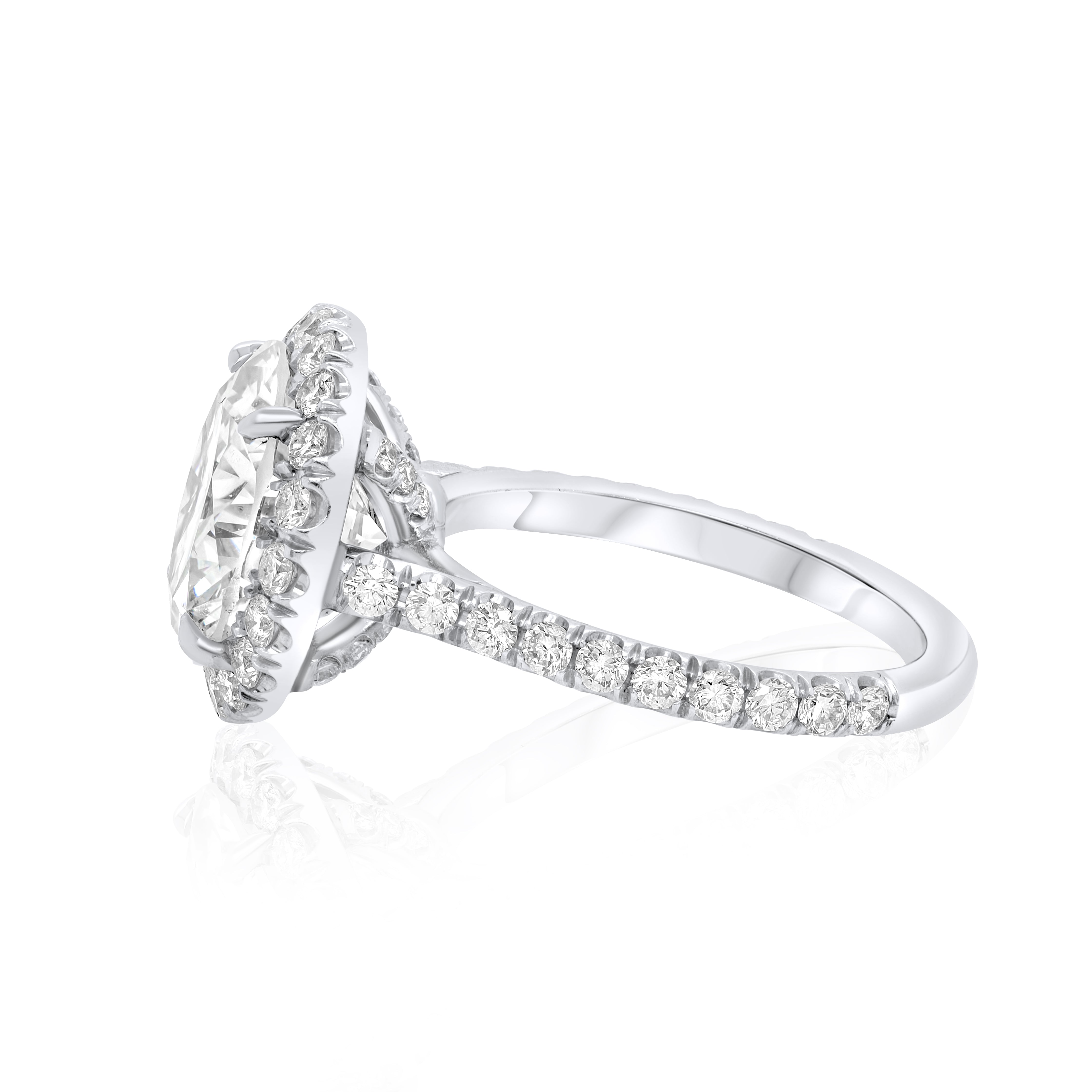 Side profile of round diamond halo engagement ring showing band height and prong setting