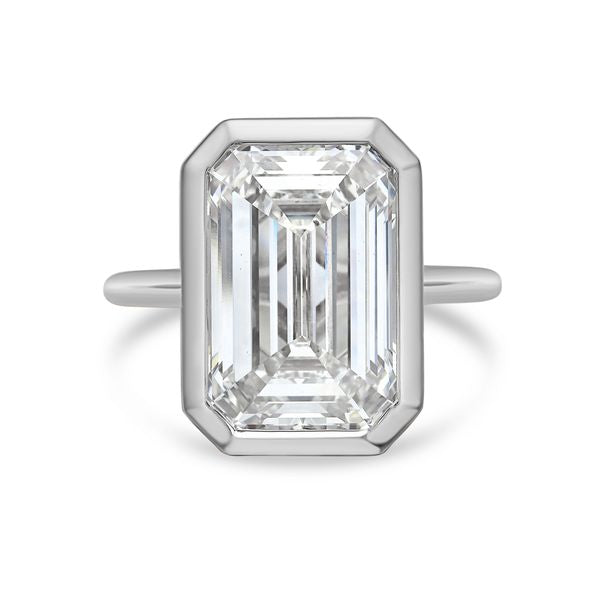 Bezel set emerald-cut lab diamond solitaire ring in 18K yellow gold