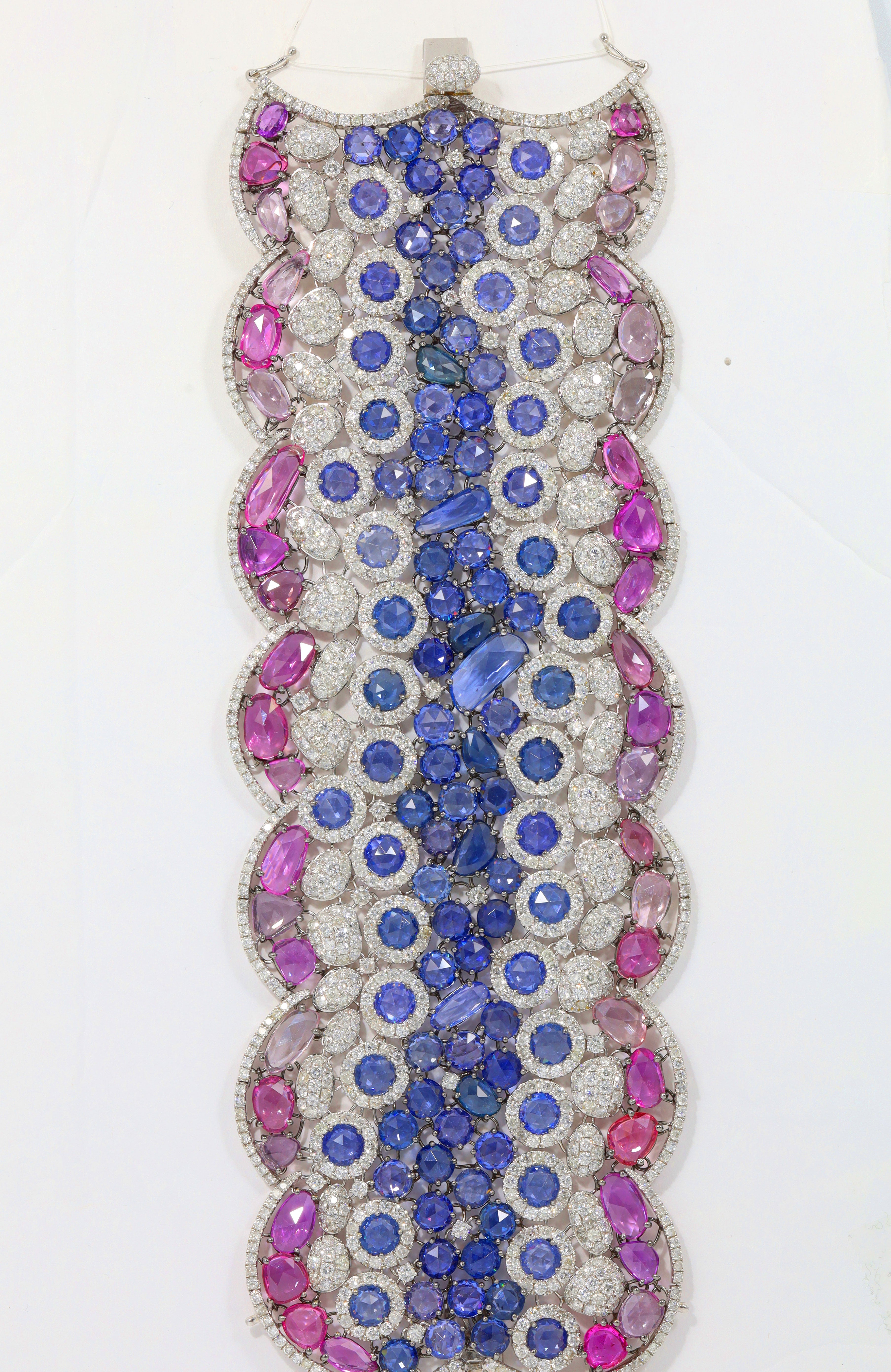 Elegant bracelet with pink, blue, and clear gemstones on a white background