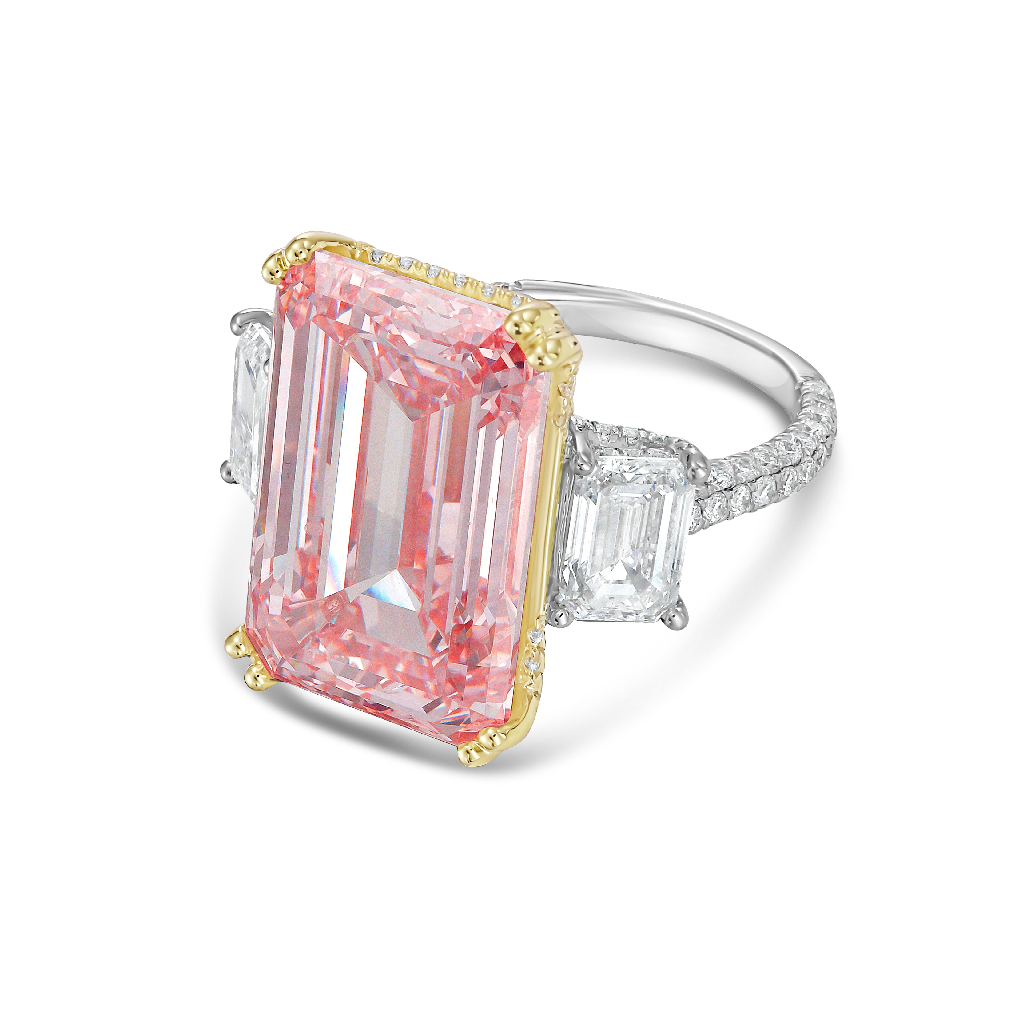 Ring with a pink emerald-cut diamond and gold and silver accents on a white background