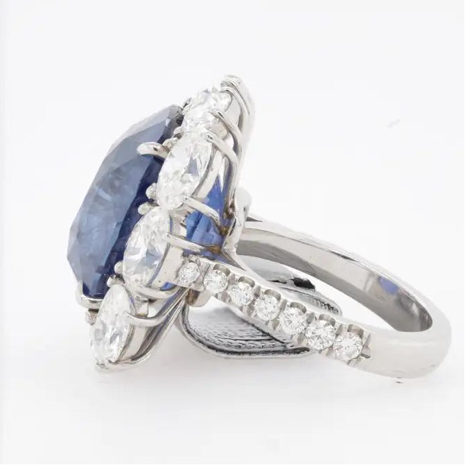 GRS certified blue sapphire statement ring with large diamond halo in platinum