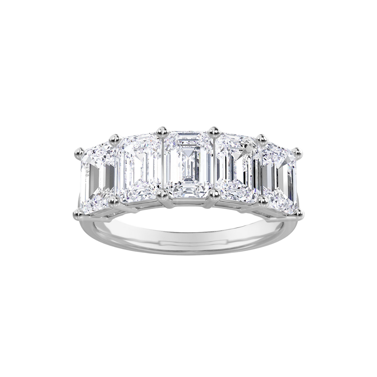 A white gold band ring with five lab grown emerald stones set in it.
