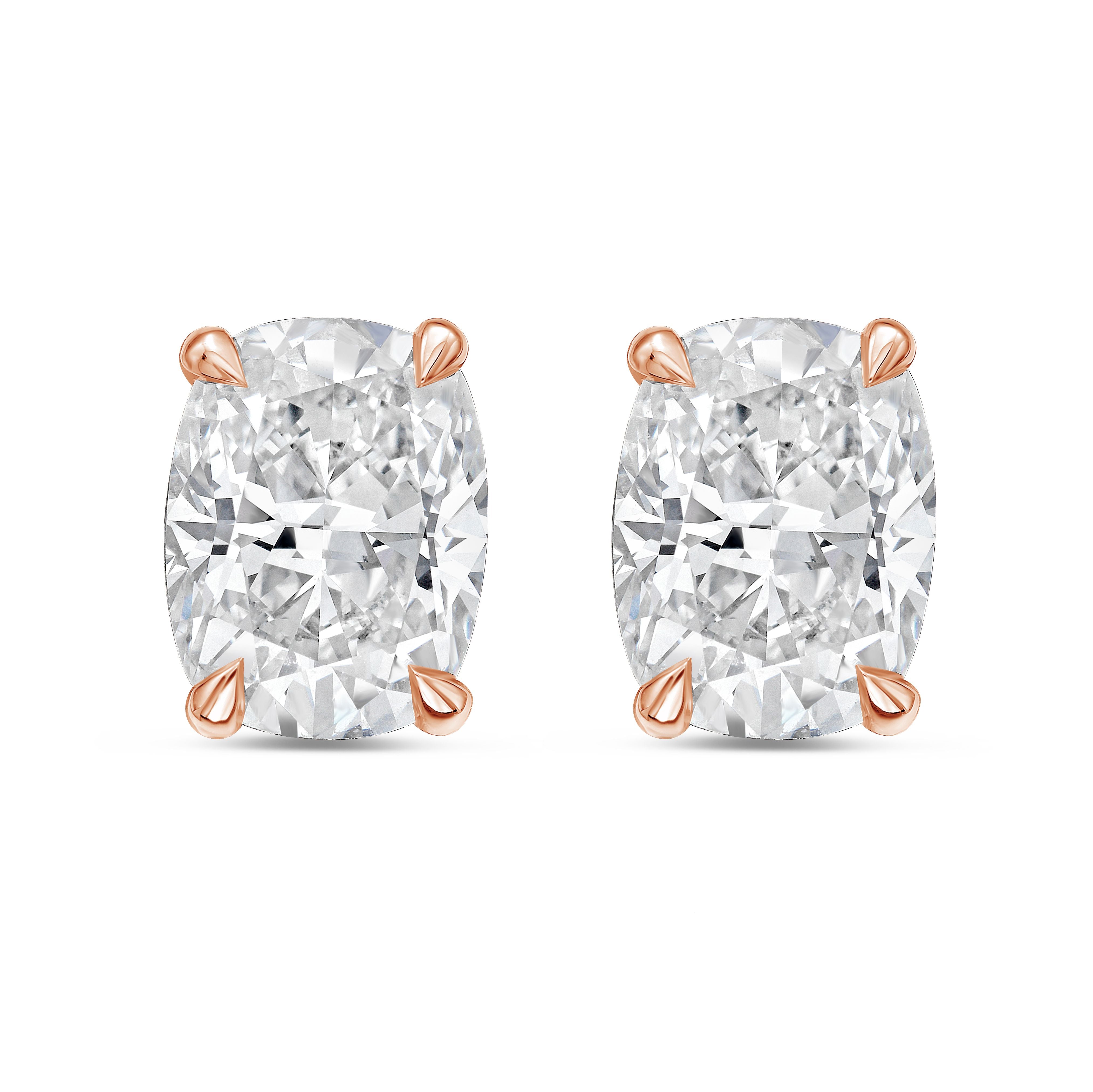Pair of diamond stud earrings with rose gold prongs on a white background