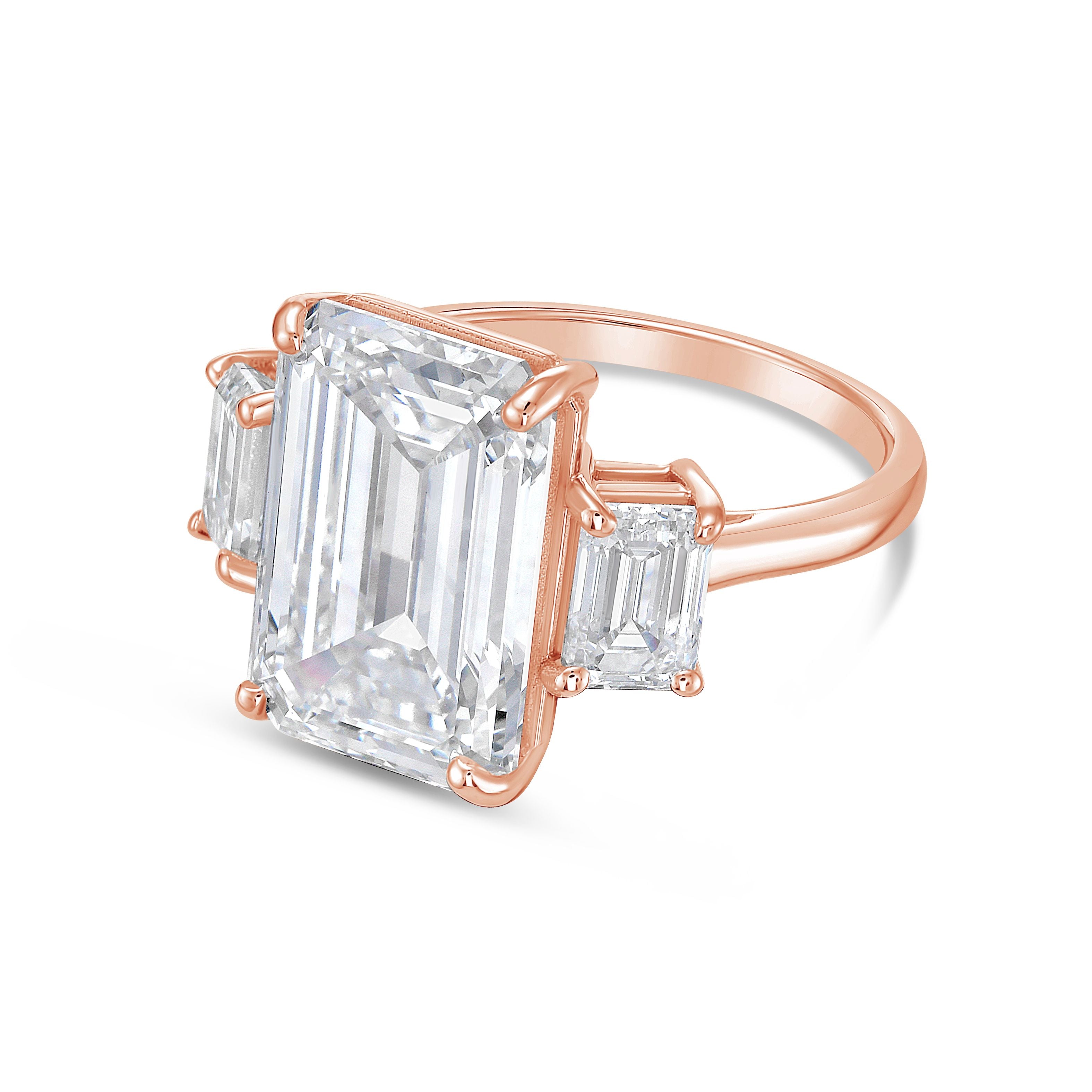 Rose gold ring with emerald-cut diamonds on a white background