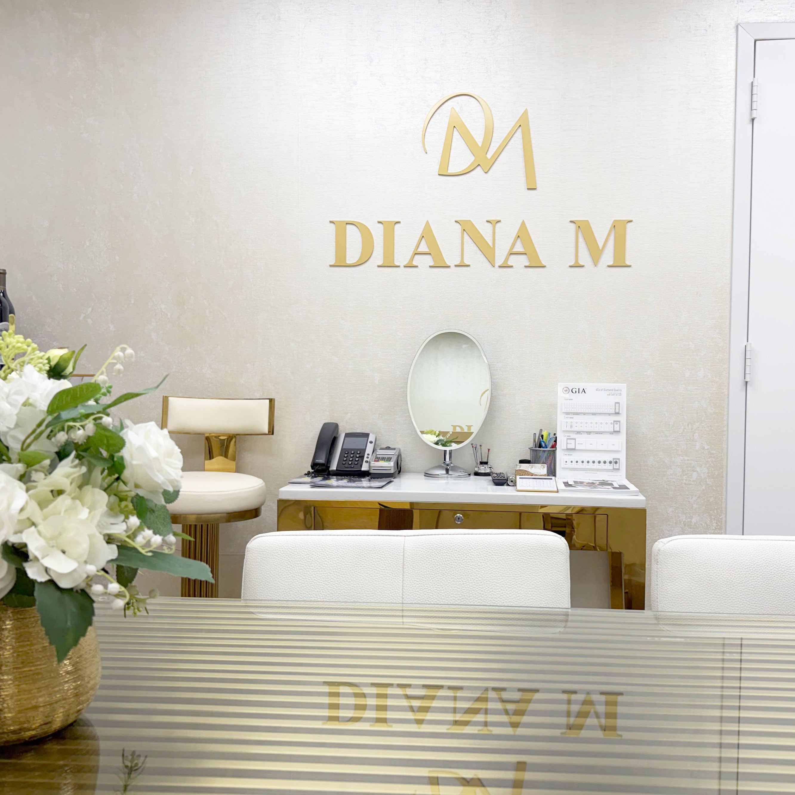 Interior of a jewelry showroom with 'Diana M' branding on decor elements.