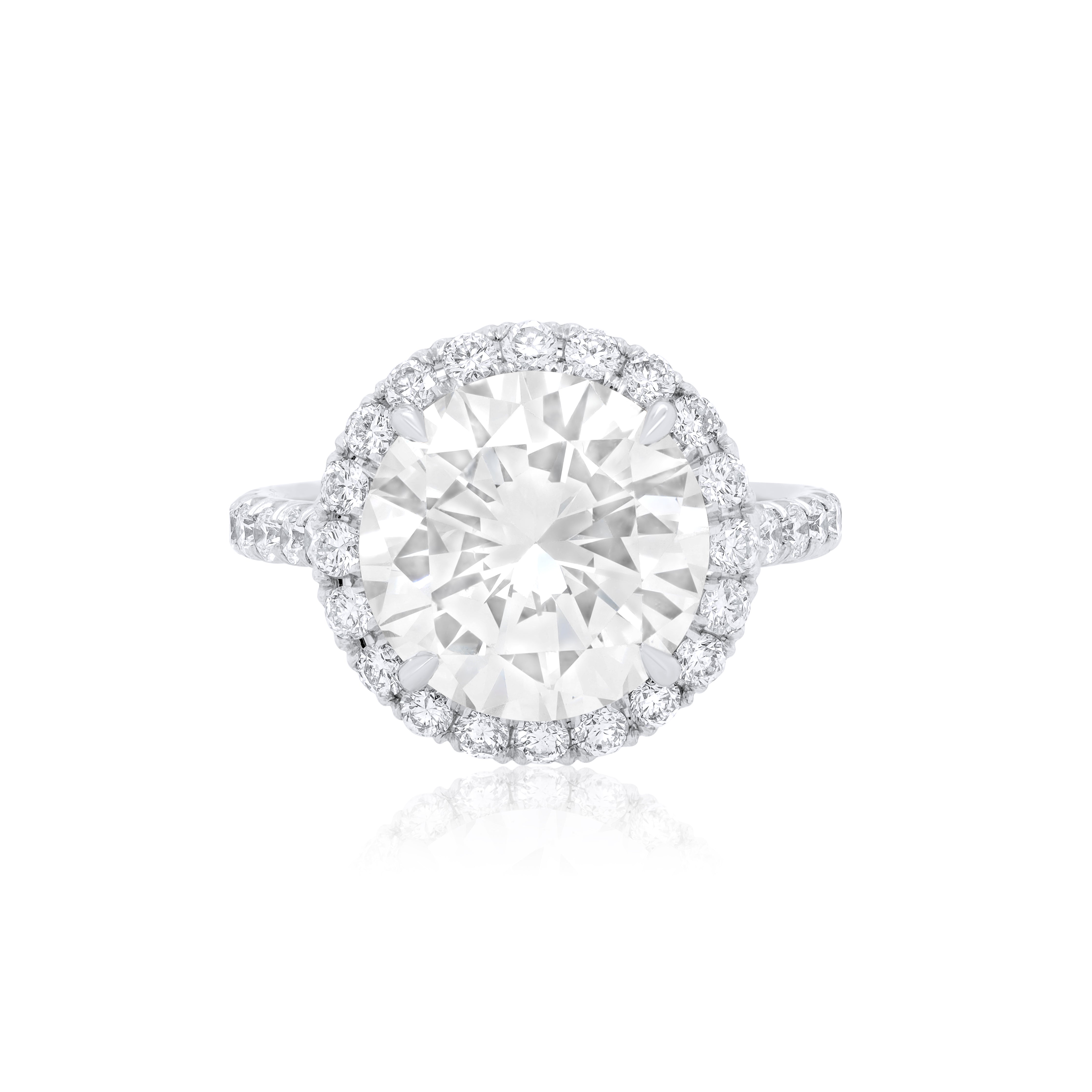 Lab-grown round diamond halo engagement ring in 18k white gold with pavé halo and pavé band