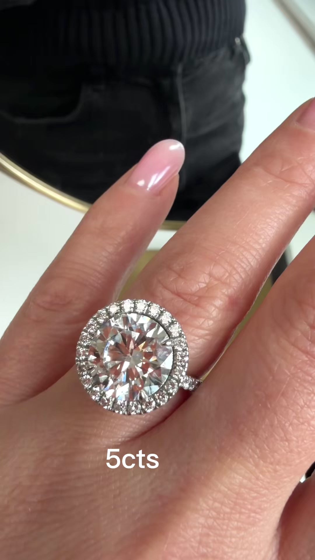 Video showing lab-grown round diamond halo engagement ring rotating to display the pavé halo and band in 18k gold