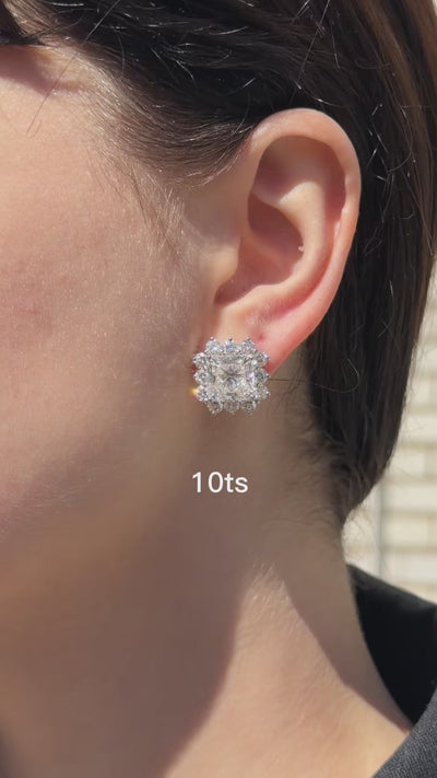 Video showing radiant cut diamond sunburst halo earrings rotating in 14k gold