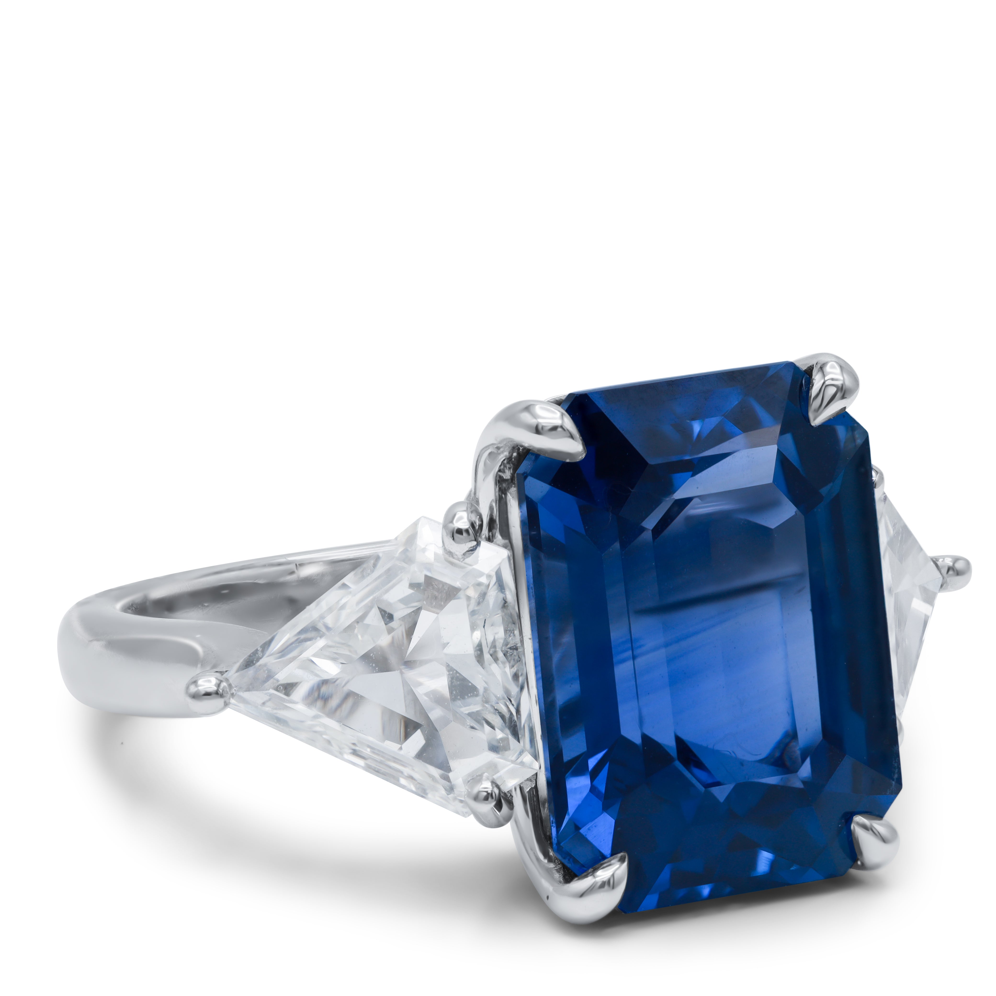 Side profile of 9.85ct Ceylon sapphire three-stone ring showing platinum setting and triangle diamond placement