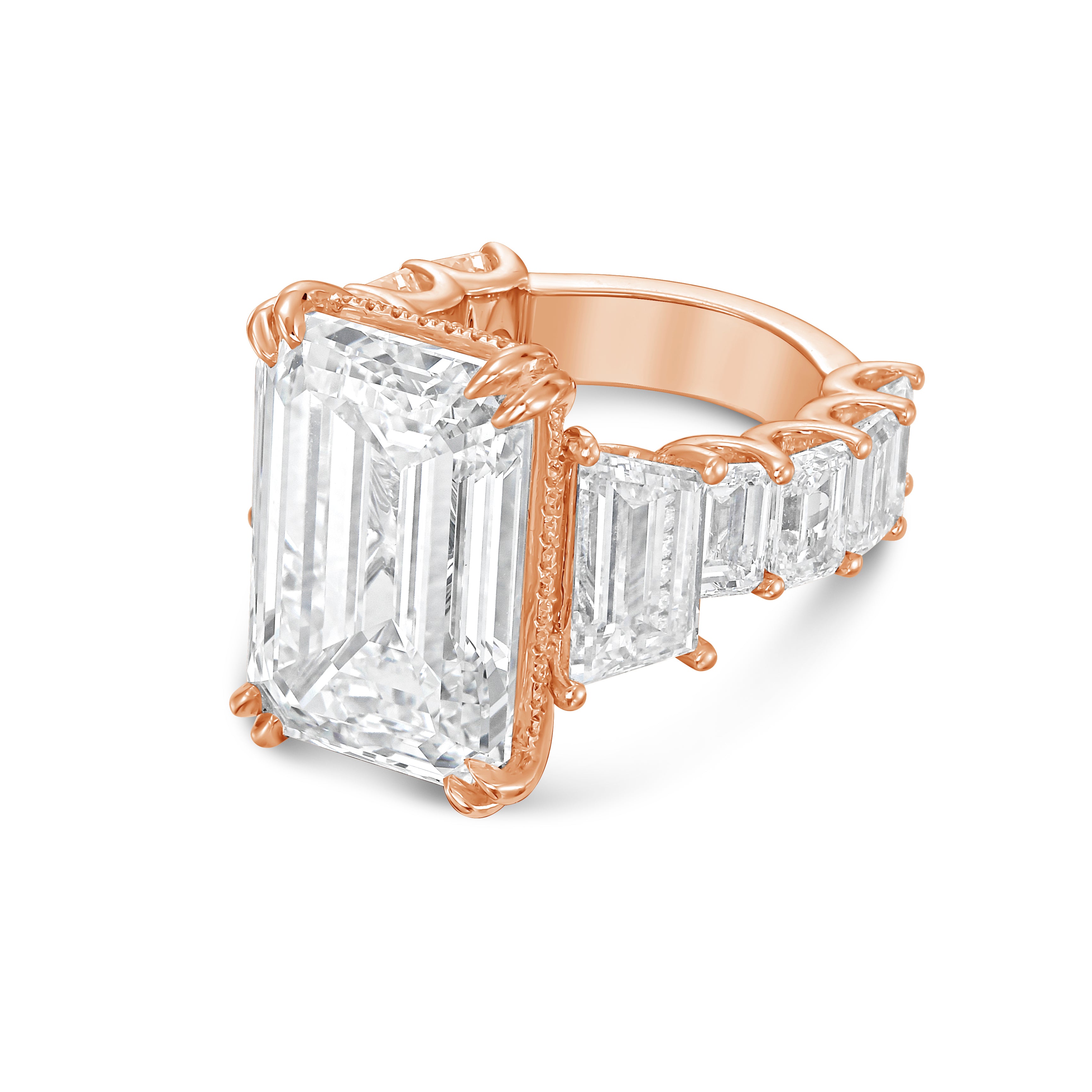 Side profile of 18k rose gold emerald cut diamond ring with green emerald gallery