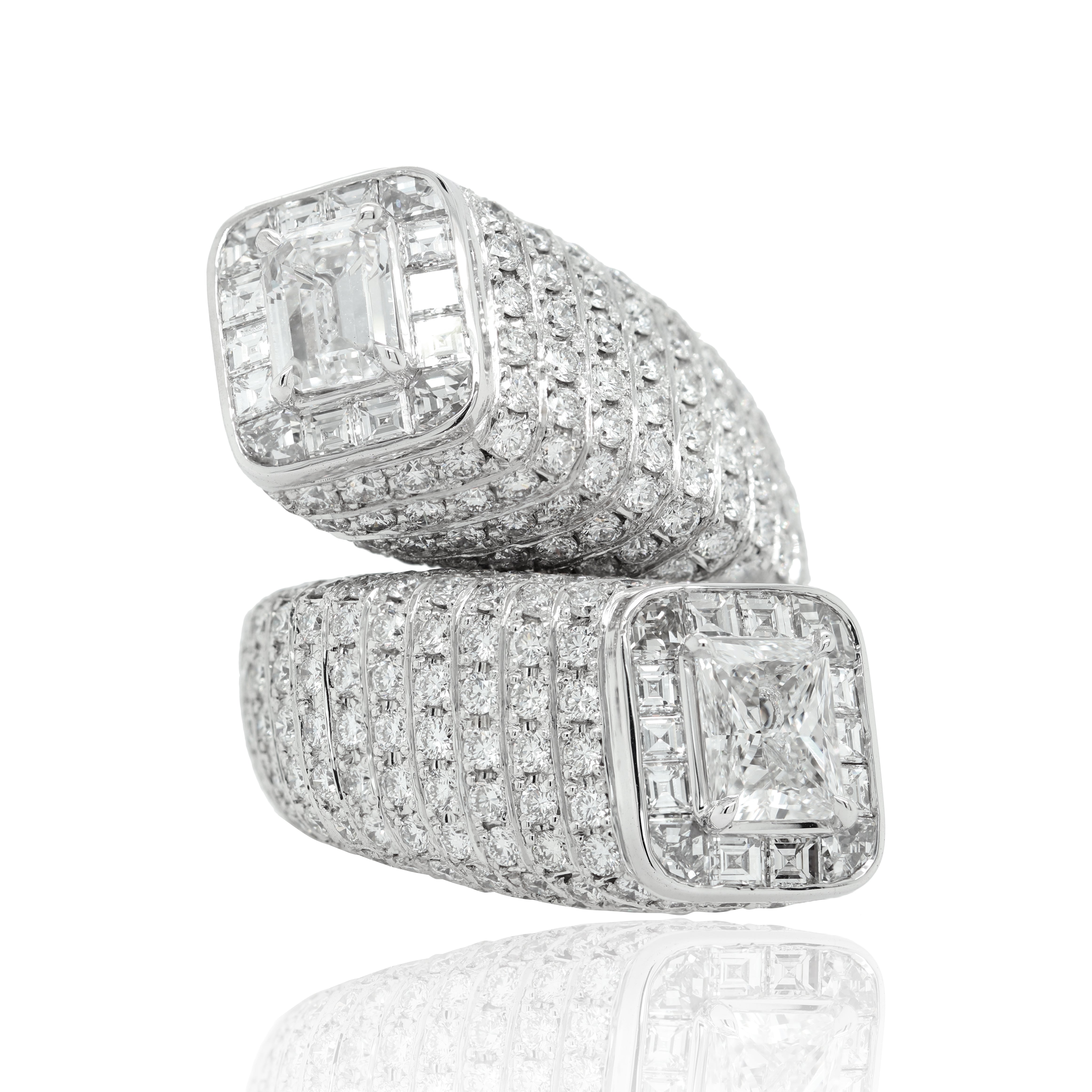 A white gold band with a square emerald cut diamond in the center, surrounded by brilliant cut diamonds set in a halo pattern.
